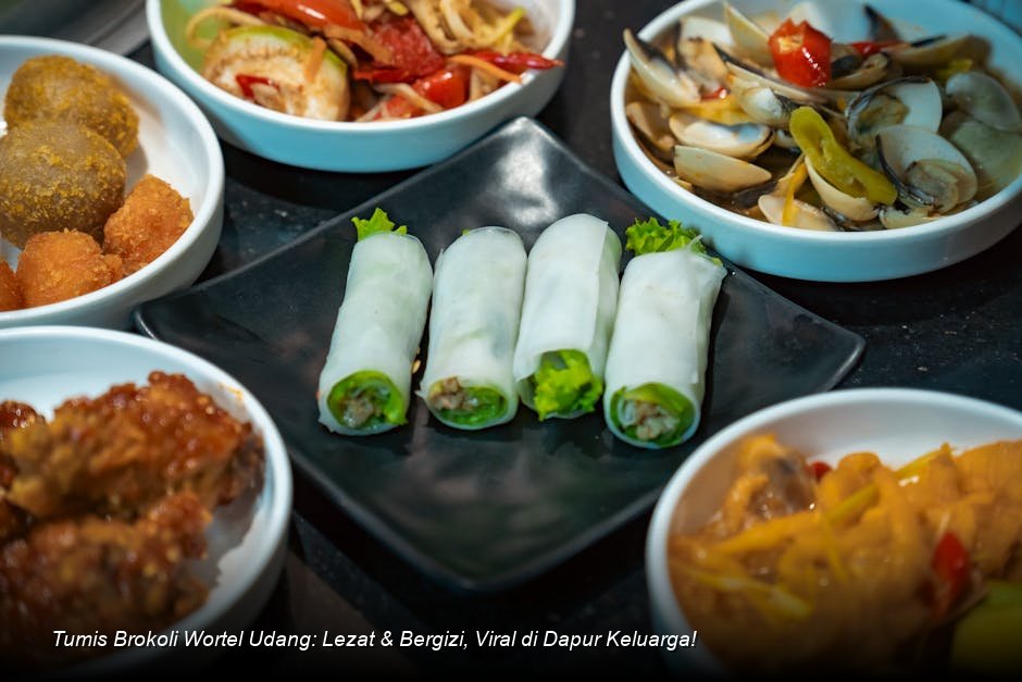 Tumis brokoli, wortel, dan udang yang menggugah selera tersaji hangat di piring keramik putih, dihiasi taburan wijen dan irisan cabai merah.