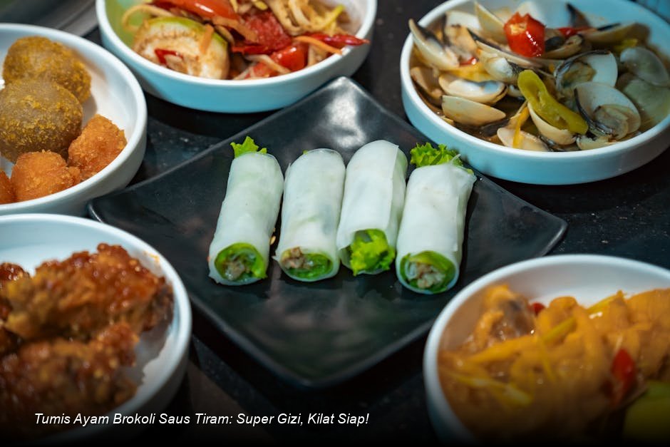 Seporsi Tumis Ayam Brokoli Saus Tiram yang menggugah selera, disajikan di piring keramik putih dengan taburan wijen dan irisan cabai merah sebagai garnish.
